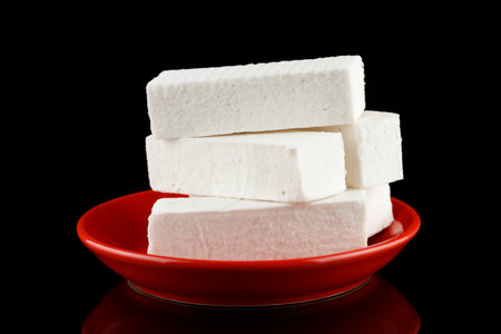 Pastilla white confectionery product on a red plate.の写真素材
