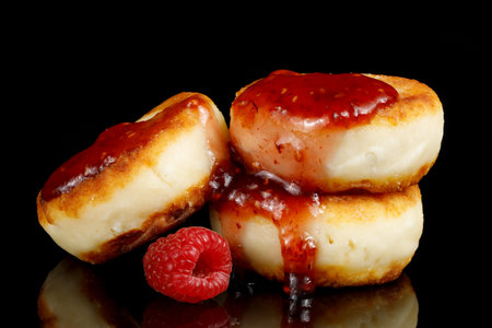 curd fritters and raspberry jam on black isolate.の写真素材