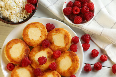 curd fritters and raspberries. Cheese fritters, pancakes or syrnikiの写真素材