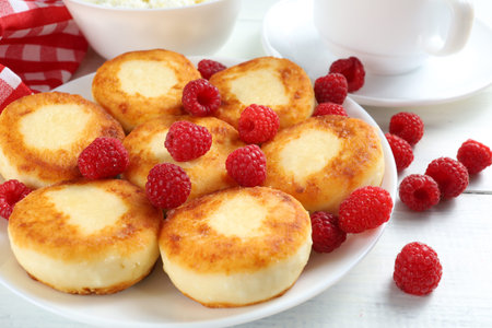 curd fritters with raspberries Traditional breakfast. Food on a bright table.の写真素材