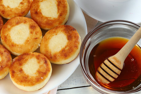 curd fritters with honey. Hearty and healthy breakfast. traditional food.の写真素材