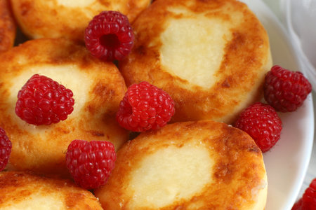curd fritters and raspberries. Cottage cheese pancakes with raspberriesの写真素材