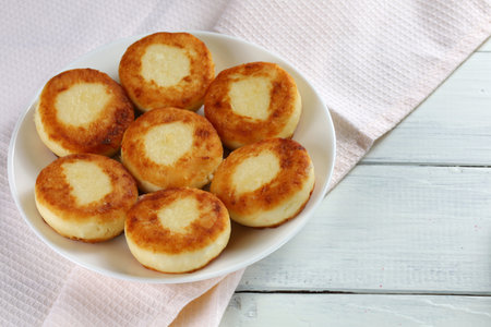 curd fritters on a white plate. A light and tasty breakfast. Photo in light style.の写真素材