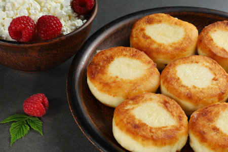 curd fritters on a plate with raspberries. Delicious homemade food.の写真素材