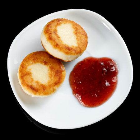 curd fritters in a plate with raspberry jam.の写真素材