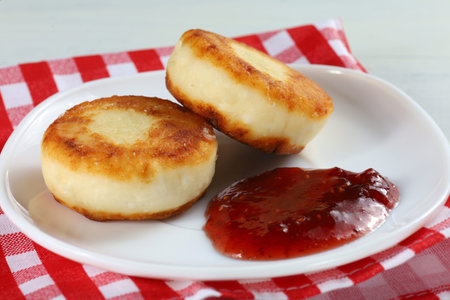 curd fritters in a plate with raspberry jam.の写真素材