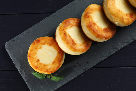 curd fritters on shale Photo in dark style. beautiful food photo.の写真素材
