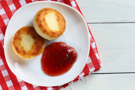 curd fritters in a plate with raspberry jam.の写真素材
