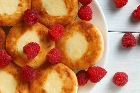 curd fritters on a plate with raspberries. Delicious homemade food.の写真素材