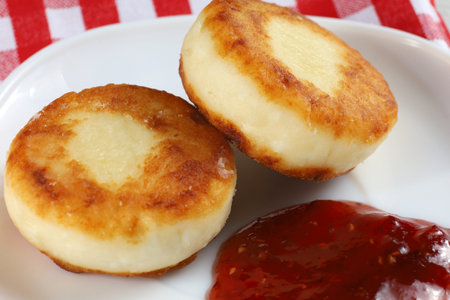 curd fritters in a plate with raspberry jam.の写真素材