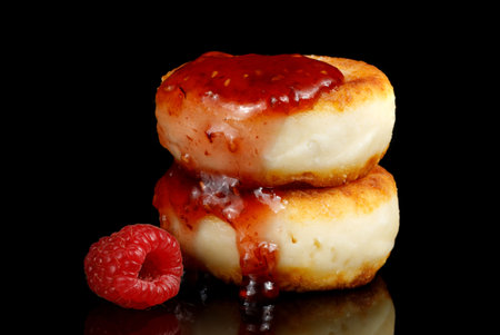 curd fritters and raspberry jam on black isolate.の写真素材