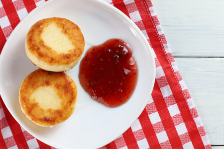 curd fritters in a plate with raspberry jam.の写真素材