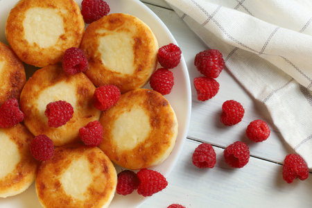 curd fritters on a plate with raspberries. Delicious homemade food.の写真素材