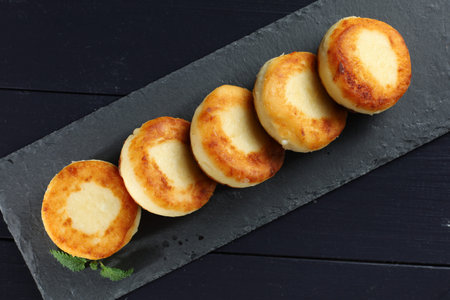 curd fritters on shale Photo in dark style. beautiful food photo.の写真素材