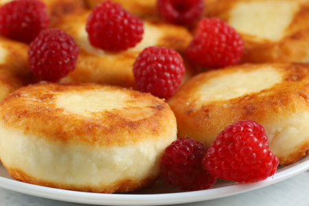 curd fritters and raspberries. Cheese fritters, pancakes or syrnikiの写真素材