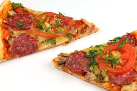 Sliced pizza on white isolate. two slices of pizzaの写真素材