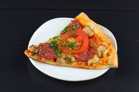 Sliced pizza in a plate. Close up view of a slice of a pizzaの写真素材