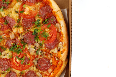Pizza with sausage in a box on a white isolate. Hot Pizza in an open cardboard box.の写真素材