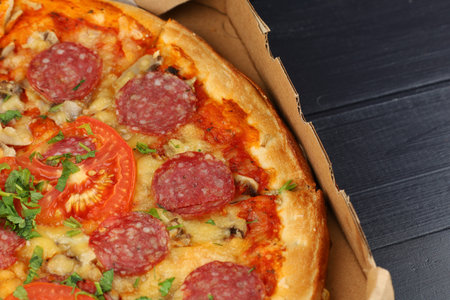 pizza box open. Pizza in the delivery box against a dark backgroundの写真素材