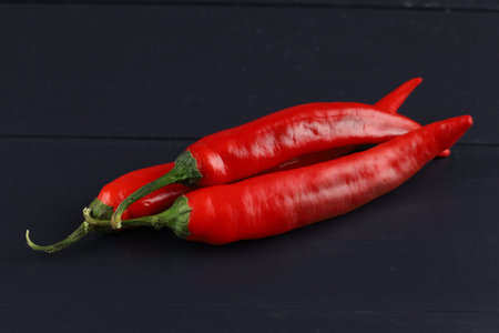 Hot red pepper on a black boardの写真素材