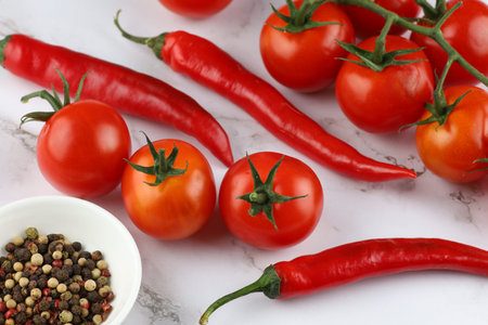 Hot red pepper with tomatoes.の写真素材
