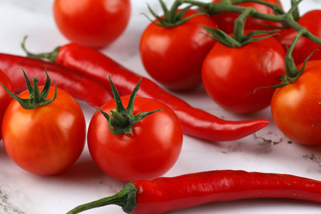 Hot red pepper with tomatoes.の写真素材