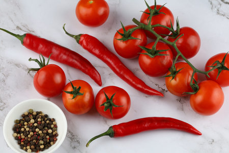 Hot red pepper with tomatoes. Fresh cherry tomatoes with red pepperの写真素材