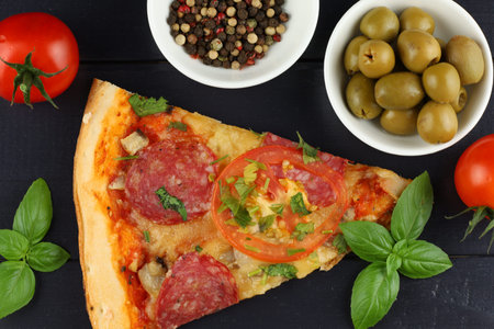 Sliced pizza on the table in the restaurant. Italian pizza on wooden table backgroundの写真素材