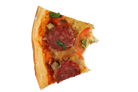 A piece of pizza is bitten. Pizza with salami and tomatoes isolate.の写真素材
