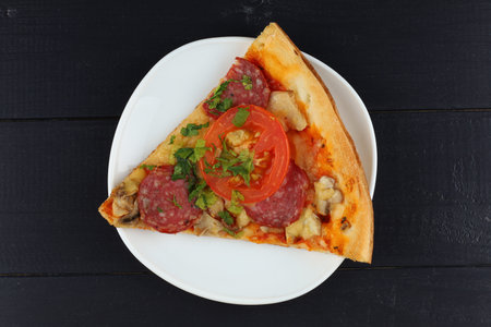 Sliced pizza in a plate. Close up view of a slice of a pizzaの写真素材