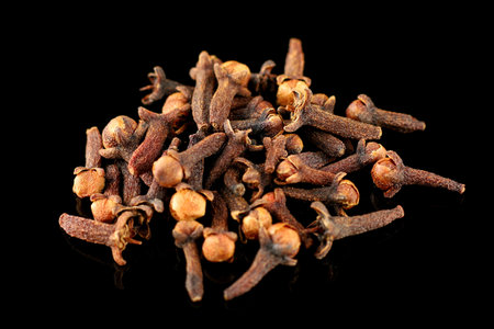 Clove spice pile on black isolateの写真素材