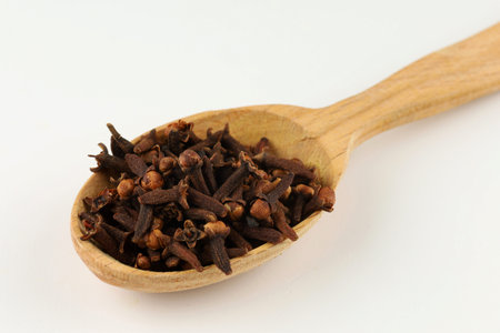 Clove spice in a wooden spoonの写真素材