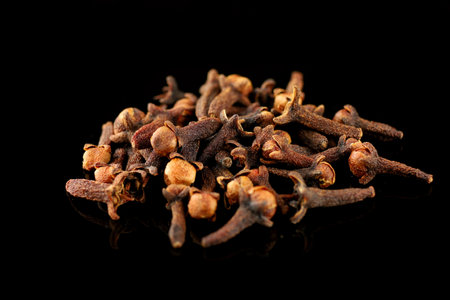 Clove spice pile on black isolateの写真素材