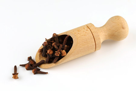 Clove spice isolate in a wooden scoopの写真素材