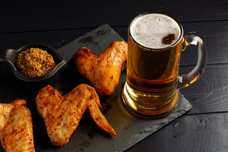 chicken wings and beer. Hearty and tasty food. Plate of delicious barbecue chicken wingsの写真素材