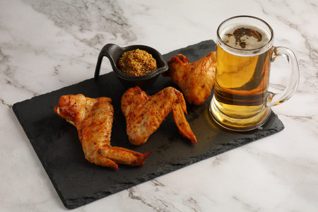 chicken wings and beer. Hearty and tasty food. Plate of delicious barbecue chicken wingsの写真素材