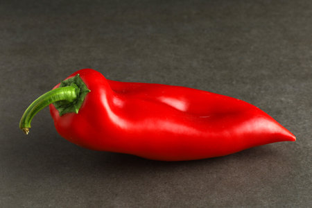 Red sweet pepper on a gray background.の写真素材