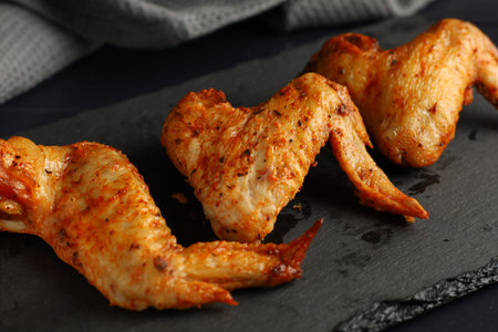 Bbq buffalo wings. Fried chicken on a dark background. delicious grilled chicken wingsの写真素材