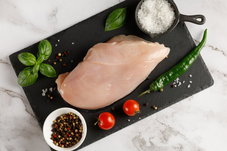 Raw chicken breasts and spices. fresh chicken breast. chicken breast fillets and seasoningsの写真素材