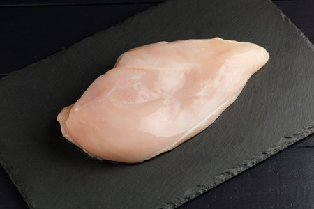 raw chicken fillet wood board top view. Fresh chicken breast with herbs and spices.の写真素材
