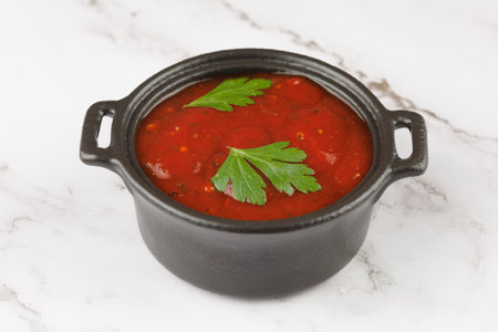 Tomato sauce with herbs. tomato ketchup in a saucepanの写真素材