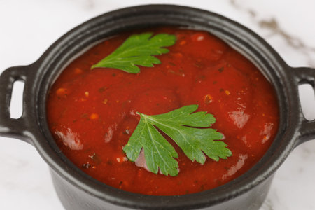 Tomato sauce with herbs. Homemade tomato Passata in black bowlの写真素材