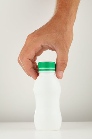 White plastic bottle in handの写真素材