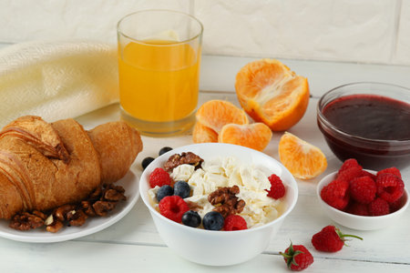 Breakfast with cheese and croissant. breakfast table with cheese, berries and croissant. top view of breakfastの写真素材