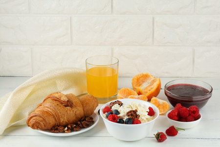 croissant breakfast with cheese, berries and nuts. Hearty and healthy food.の写真素材
