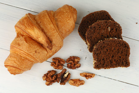 Croissant, bread and nuts. A source of protein, fat and carbohydrates. Vegetarian foodの写真素材