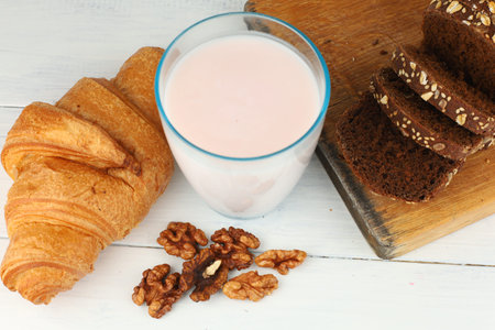 croissant breakfast with cheese, berries and nuts. Hearty and healthy food.の写真素材