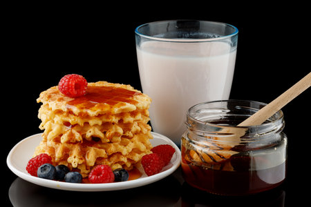 Belgian waffles with honey, yogurt and berriesの写真素材