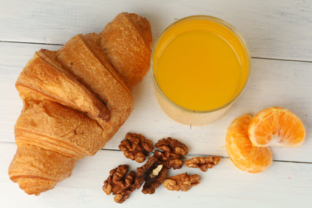 Croissant, nuts and orange juice. Healthy Eating.の写真素材