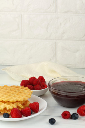 Belgian waffles with raspberry jam. Belgian waffles with berriesの写真素材